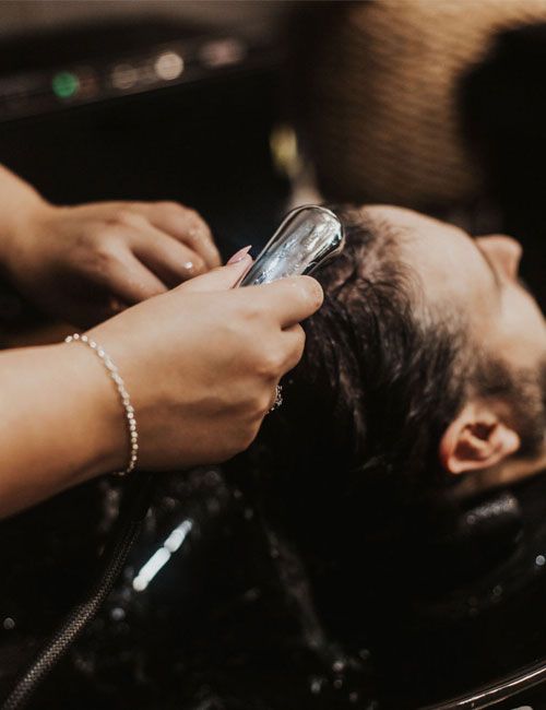 Stylist washing her client's hair